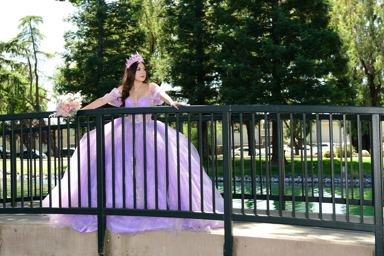 Quinceañera in lavender gown on elegant bridge