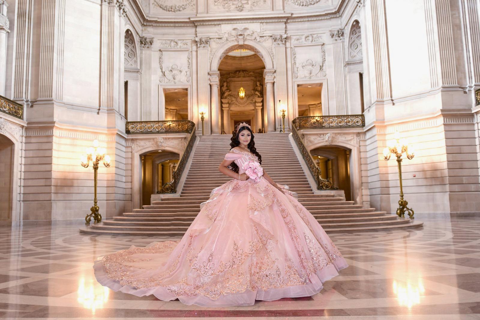 Quinceañera in pink ball gown at SF City Hall double staircase