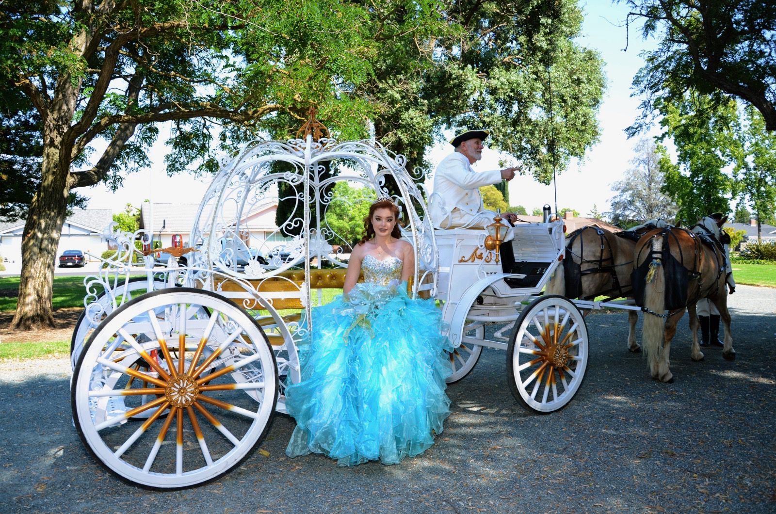 Quinceañera in teal ball gown with Cinderella carriage